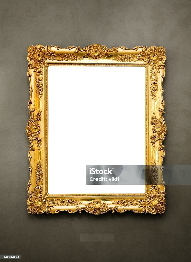 Ornate picture frame hanging on a wall Gold - Metal Stock Photo