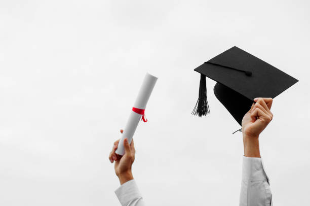 Man hand holding graduation cap, education concept. stock photo