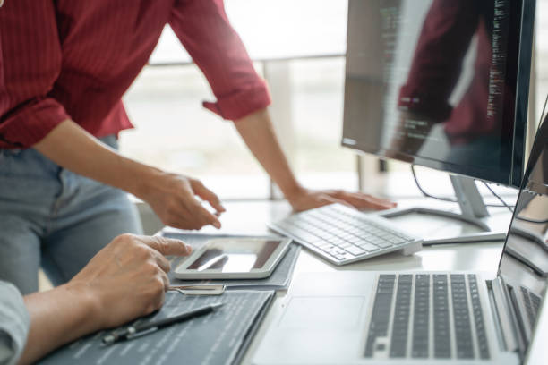 Development programmer writing a code on database, Teamwork cooperation. stock photo