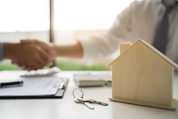 istock Real estate agent hand shaking with customer for house contract agreement. 1239833653