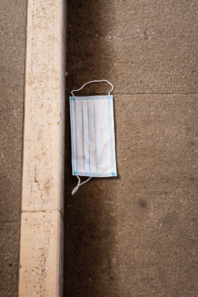 istock surgical mask on the ground 1239834732