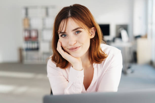 istock Pretty young office worker with a lovely smile 1239841207