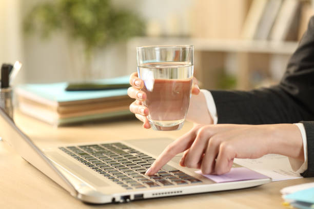 istock Entrepreneur hands holding glass of water working 1239842290
