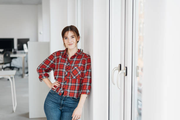istock Relaxed friendly woman leaning against a wall 1239846603