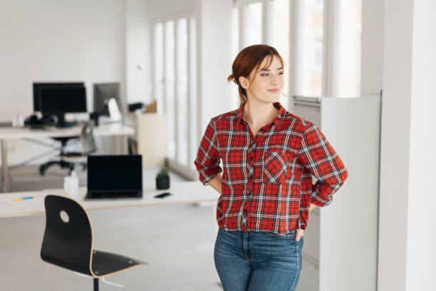 istock Relaxed young businesswoman standing watching 1239848265