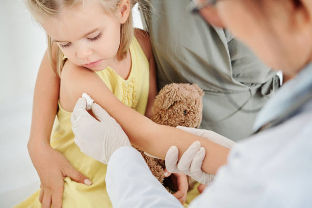 istock Pediatrician cleaning site with alcohol swab 1239852582