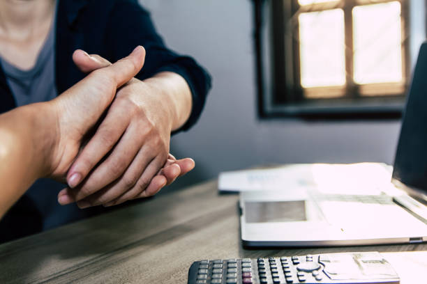 istock businessman together create a mutually beneficial business relationship. Economic graph on the table 1239861232
