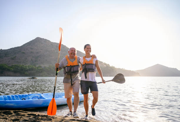 istock Spanish kayakers walking onto beach after morning paddle 1239866718