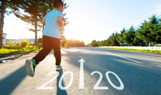 istock Boy running on the road with writing Number 2020 1239866724