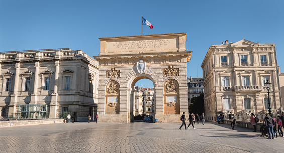 Montpellier, France - January 2, 2019: Architecture detail of the Arc de Triomphe and its street atmosphere on a winter day