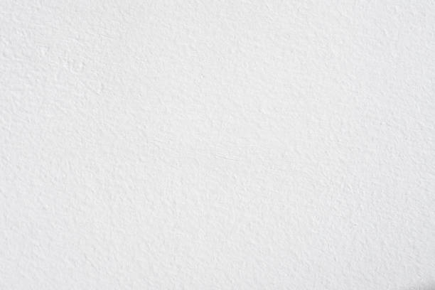 istock White concrete wall texture background and look like paper texture. 1239890395