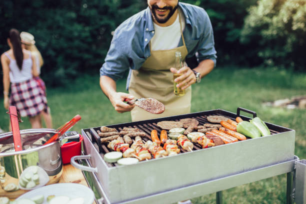 istock Young man preparing barbecue for friends outdoor 1239923363