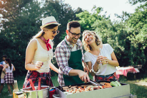 istock Friends having a barbecue party in nature 1239928080