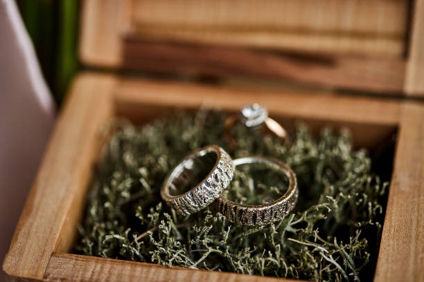 istock wedding rings lie in the wooden box 1239928702