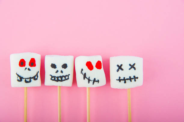 istock Marshmallows close-up and copy space on a pink background. Marshmallows for Halloween emoticons. 1239941848