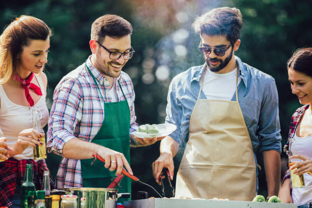 istock Friends having a barbecue party in nature 1239945643