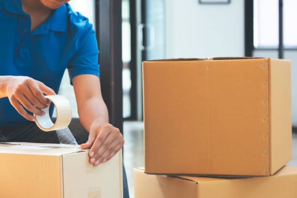 istock Small online business owner packing in the cardbox. 1239946168