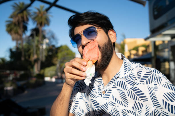 istock Man enjoying sunny weather while eating an ice cream 1239966198