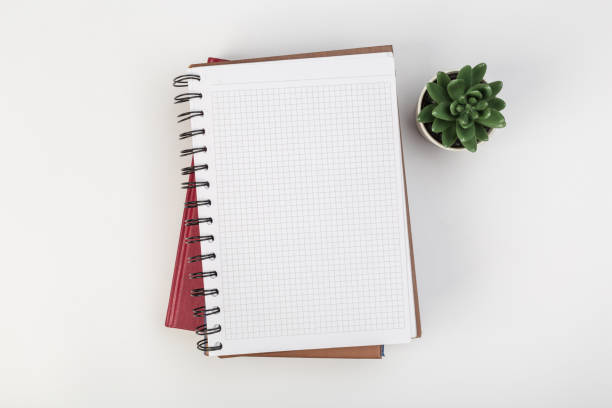 istock a stack of several spiral school notebooks lies on a white table with a pencil, office concept 1239969467