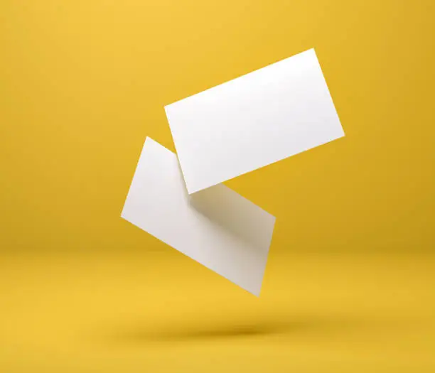 Photo of 3d illustration. Two business cards in space, for branding with shadows, on a yellow background. Render.