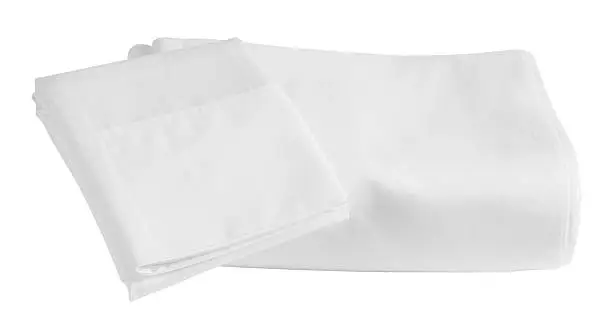 Folded bed sheet with pillow case on top.