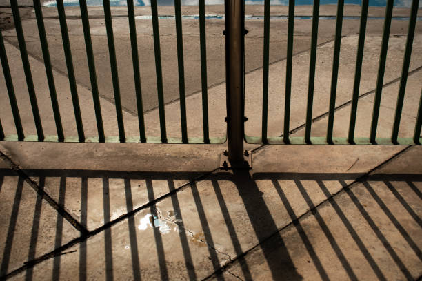 istock wrought iron fence with summer sun light background 1239984663