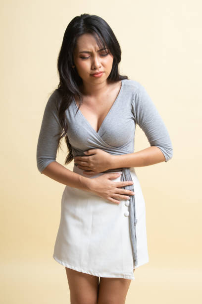 istock Young Asian woman got stomachache. 1239985192