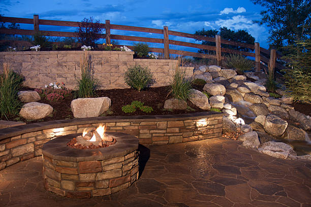 Beautiful Backyard Fire Pit and Seat Wall An amazing and beautiful backyard fire pit, seat wall and water feature. Inspiring ideas for backyards patio stock pictures, royalty-free photos & images
