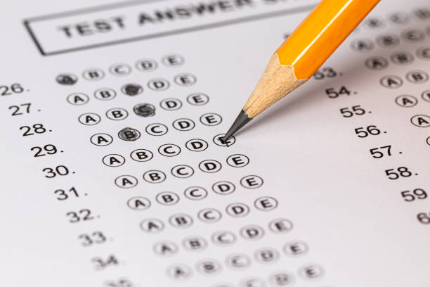 istock Answer sheet form with pencil on table, close up. Concept of passing exam 1240007930