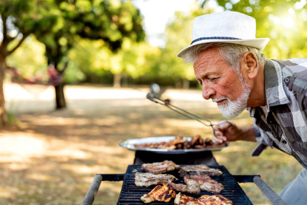 istock Barbecue outdoor in summer. Man cooking. 1240011252