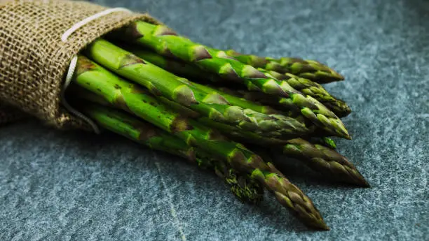 Asparagus. Fresh green asparagus on a gray slate background, Copy space top view