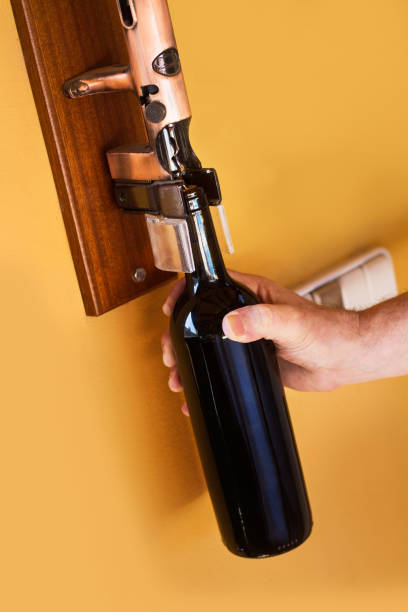 istock Man opening a bottle of red wine 1240021703