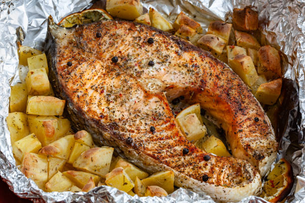 istock Salmon steak baked with lemon and herbs in foil 1240046455