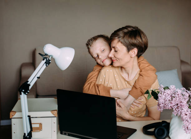 istock love baby son mom working laptop hugs 1240049713