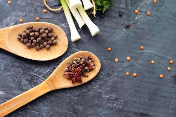 Spicy herbs, asparagus, seasonings on the kitchen table for preparing healthy homemade food from organic products