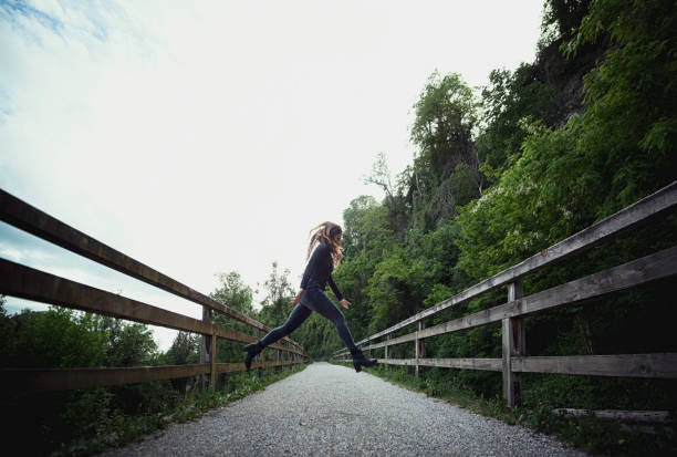 Happy young girl enjoying walking, dancing, jumping. Freestyle. Freedom and carefree. Individuality, alternative lifestyle. Activity summer vacations. Lifestyle photography. Blurred motion