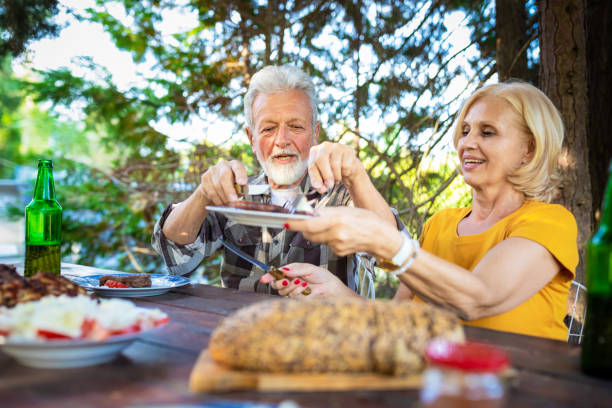 istock Senior people having lunch in garden 1240055778