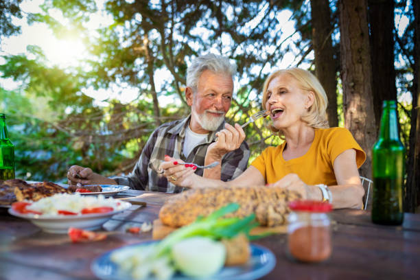 istock Senior people having lunch in garden 1240057415