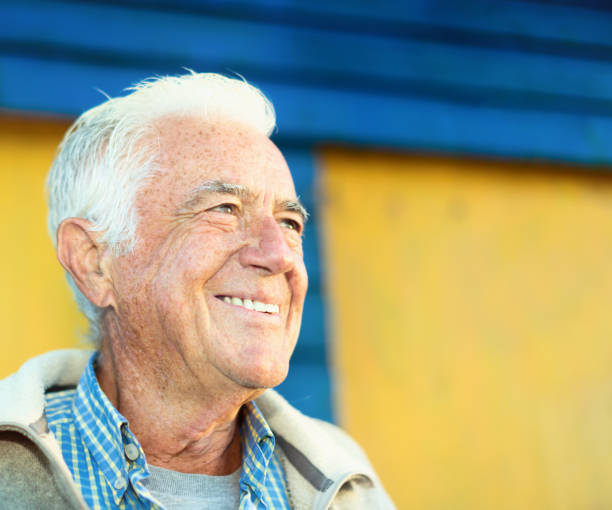 istock Active, smiling senior man outdoors by a brightly painted colorful building 1240067642
