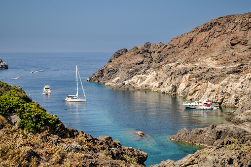 Cove with sailboats anchored on the Costa Brava North, Cap de Creus, in Catalonia, Spain