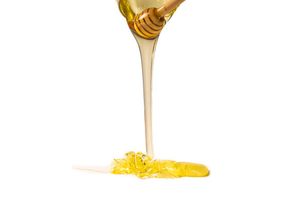 istock Dipper with honey on a white background. 1240072438