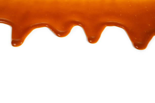 istock Background of flowing caramel sauce isolated on white. 1240072475