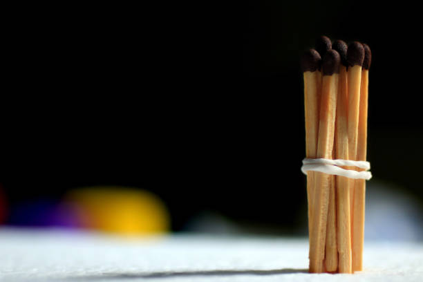 istock Wooden matches tied up on black background. 1240093505