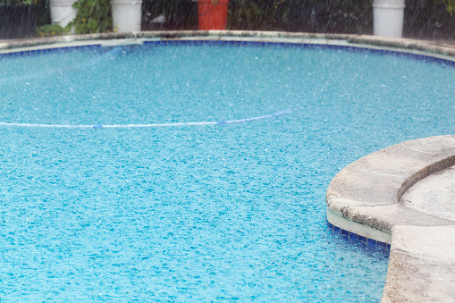 Rain falling into swimming pool