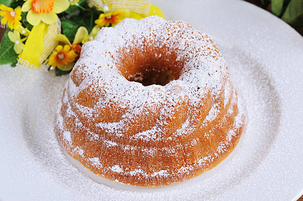 Arrangement with some utensils and ingredients for a bundt cake made at home. Directly above view
