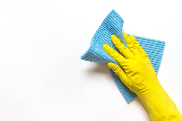 istock Cleaning hand in yellow rubber glove with blue cloth 1240110690