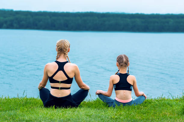 istock Woman and child doing exercise outdoor 1240113945