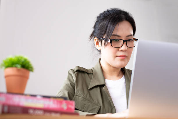 istock Modern young Asian woman working from home. 1240116610