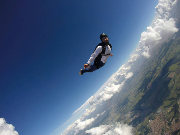 istock Skydiver jumping free with the clouds. 1240120391