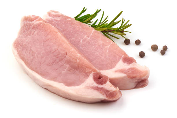 istock Sliced raw pork steaks, isolated on white background. 1240135785